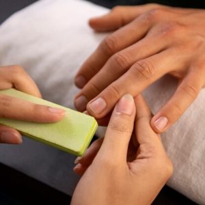 high-angle-man-getting-manicure_23-2149975495